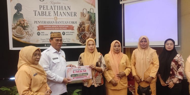 Sekda Iwan Mustapa didampingi Ketua DWP Bone Bolango, dr.Nurliana Ibrahim saat menyerahkan bantuan modal UMKM. (Sumber Foto: Kominfo)